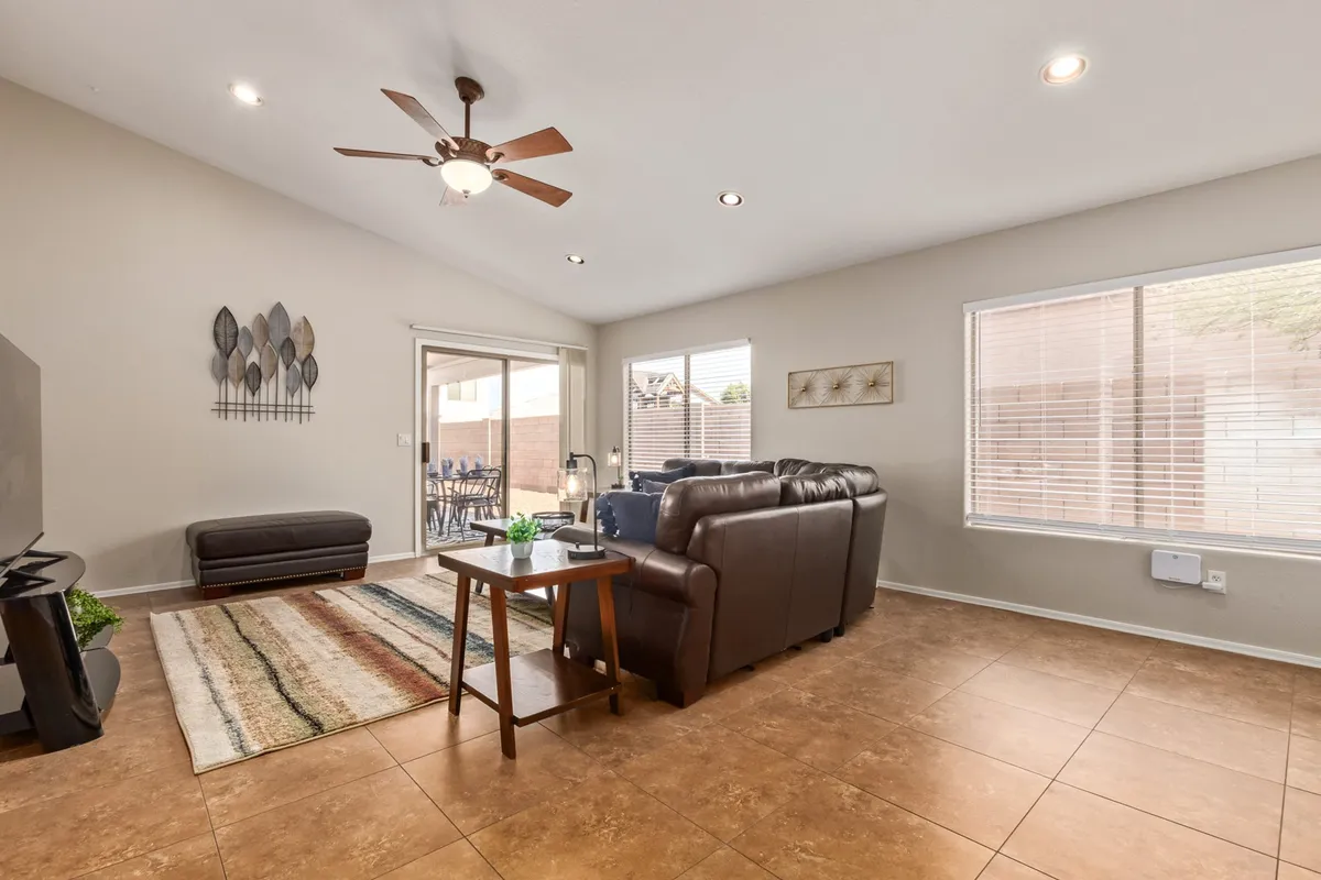 A stylish interior scene with a sofa, coffee table, and a window view that lets in natural light. The arrangement suggests a welcoming spot to relax, read, or entertain, and the window offers a subtle nod to the outside world and the feeling of spaciousness.