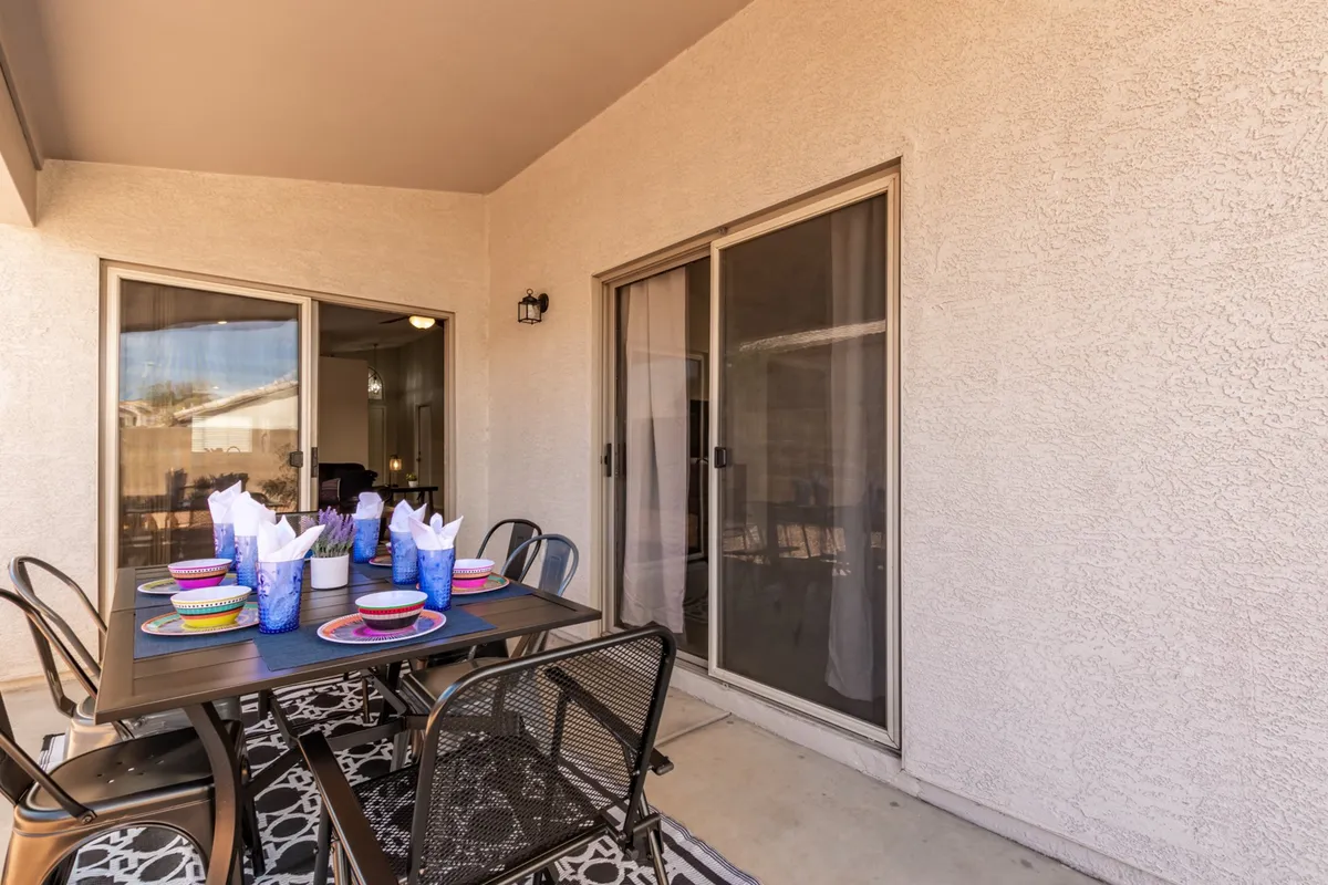 An outdoor dining table set for a festive meal, surrounded by cheerful decor and open sky. The scene is vibrant and ready for family or friends to enjoy memorable dinners under the stars, suggesting pre- or post-game celebrations.